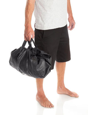 Surfer Using the Surflogic Change Mat Duffle Bag Handles Carry Bag Feature