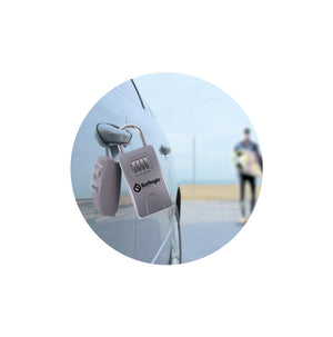 Surflogic Silver Maxi Key Vault Car Key Lock Box Secured on Car Door Handle and Surfer in Background